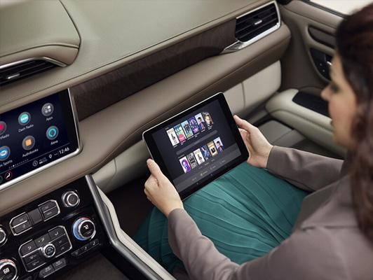 Woman inside a car with a tablet 