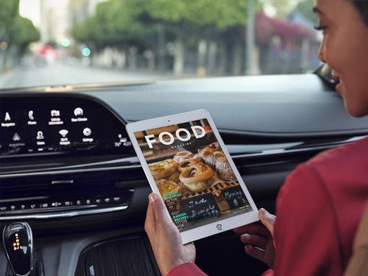 woman using tablet in car