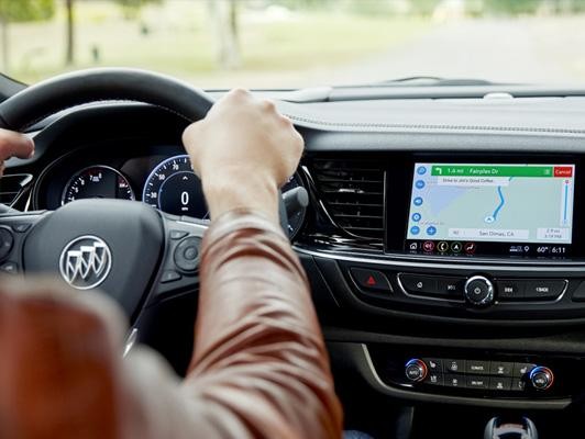 Woman driving Buick with navigation on screen