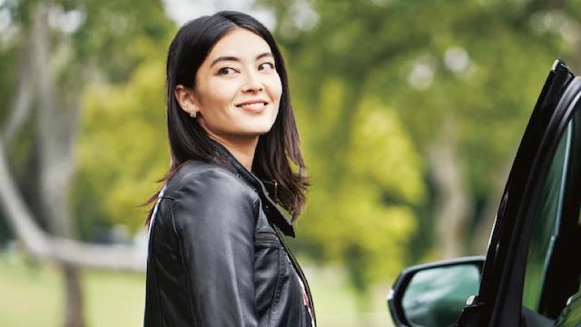 Woman standing next to vehicle