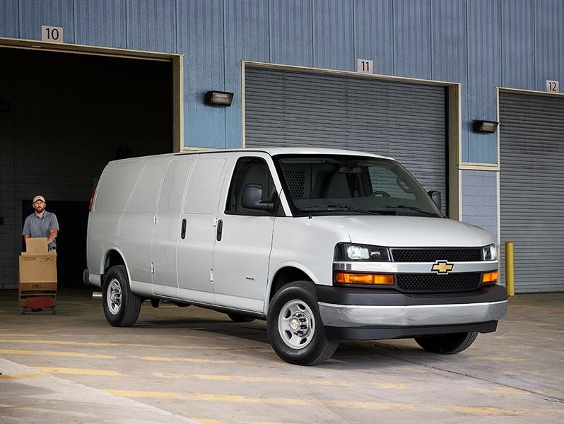 A white Chevy Express 3500 Cargo Van at a loading dock.