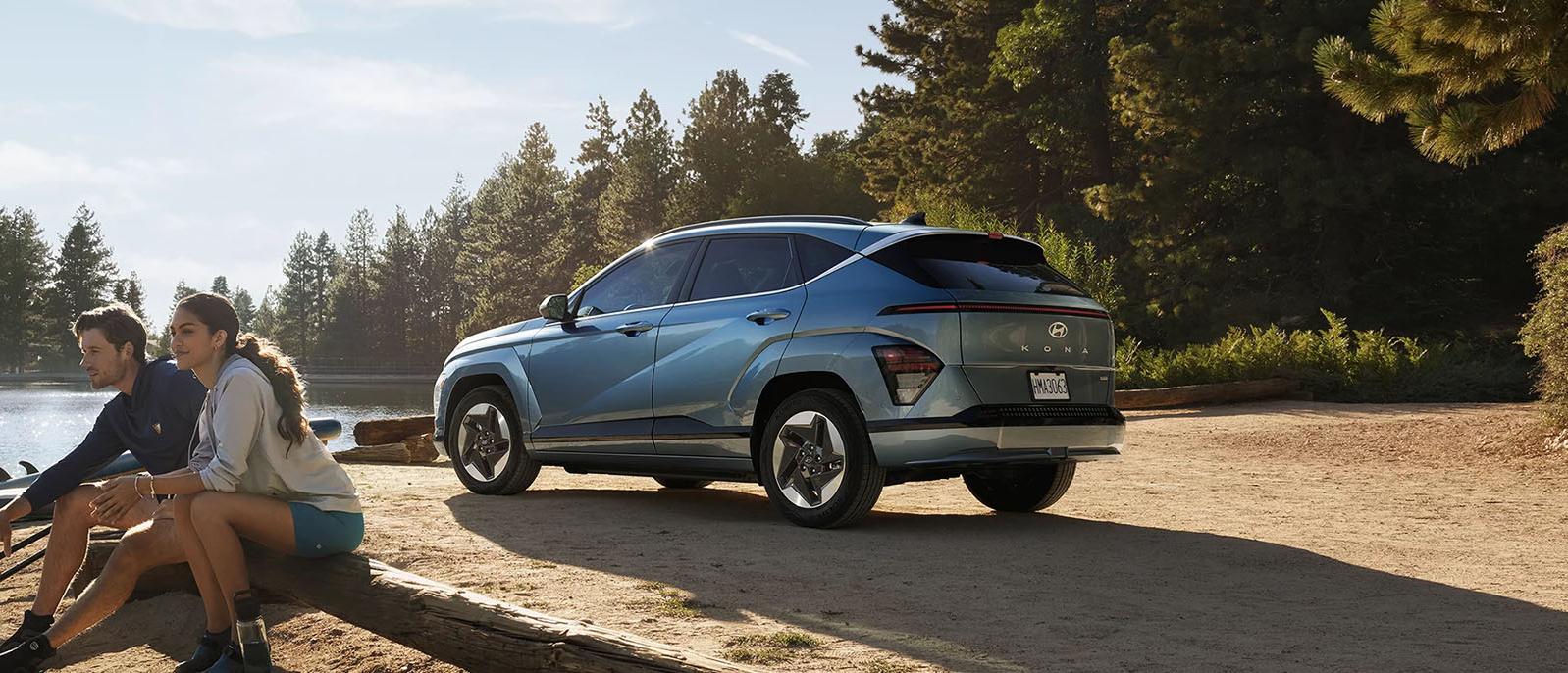 A  Hyundai Kona Electric parked in nature.