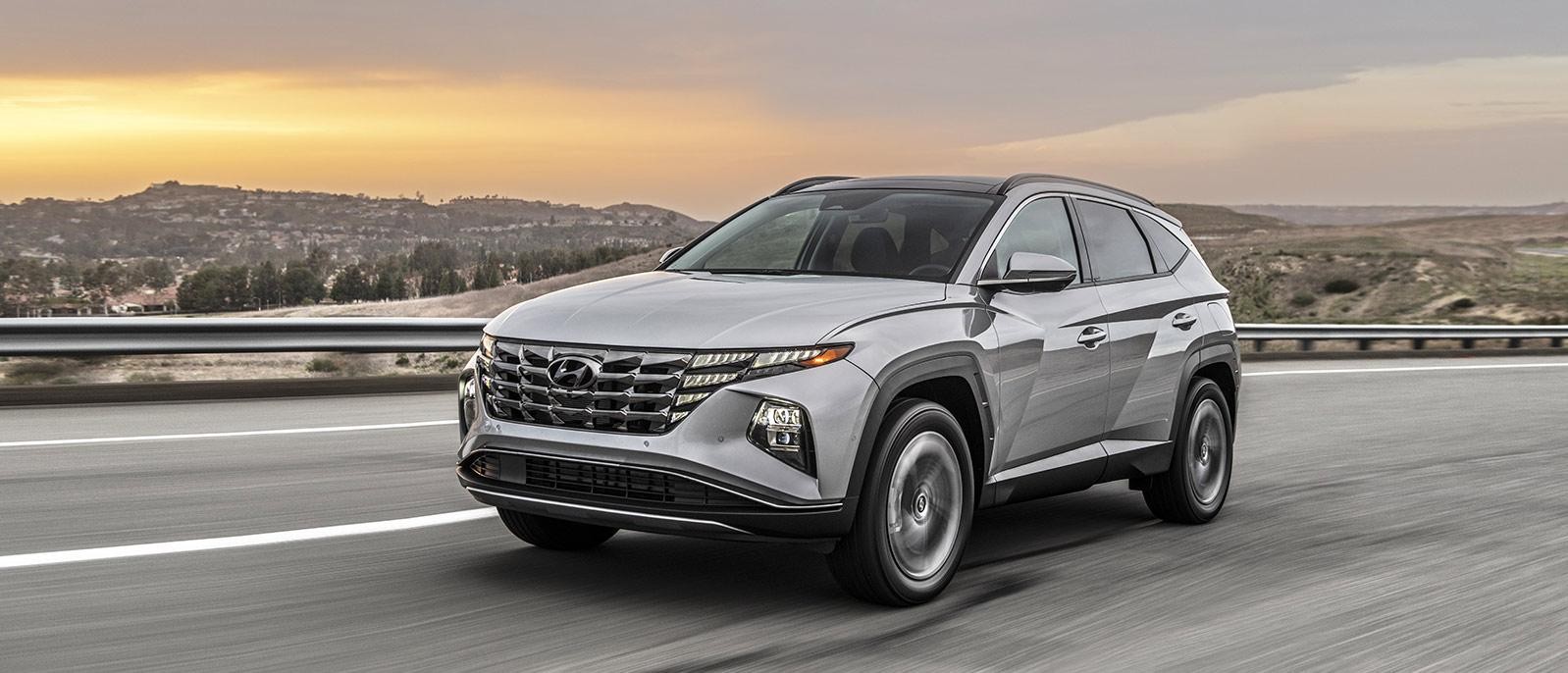 Silver 2022 Hyundai Tucson Plug-in Hybrid running on the road.