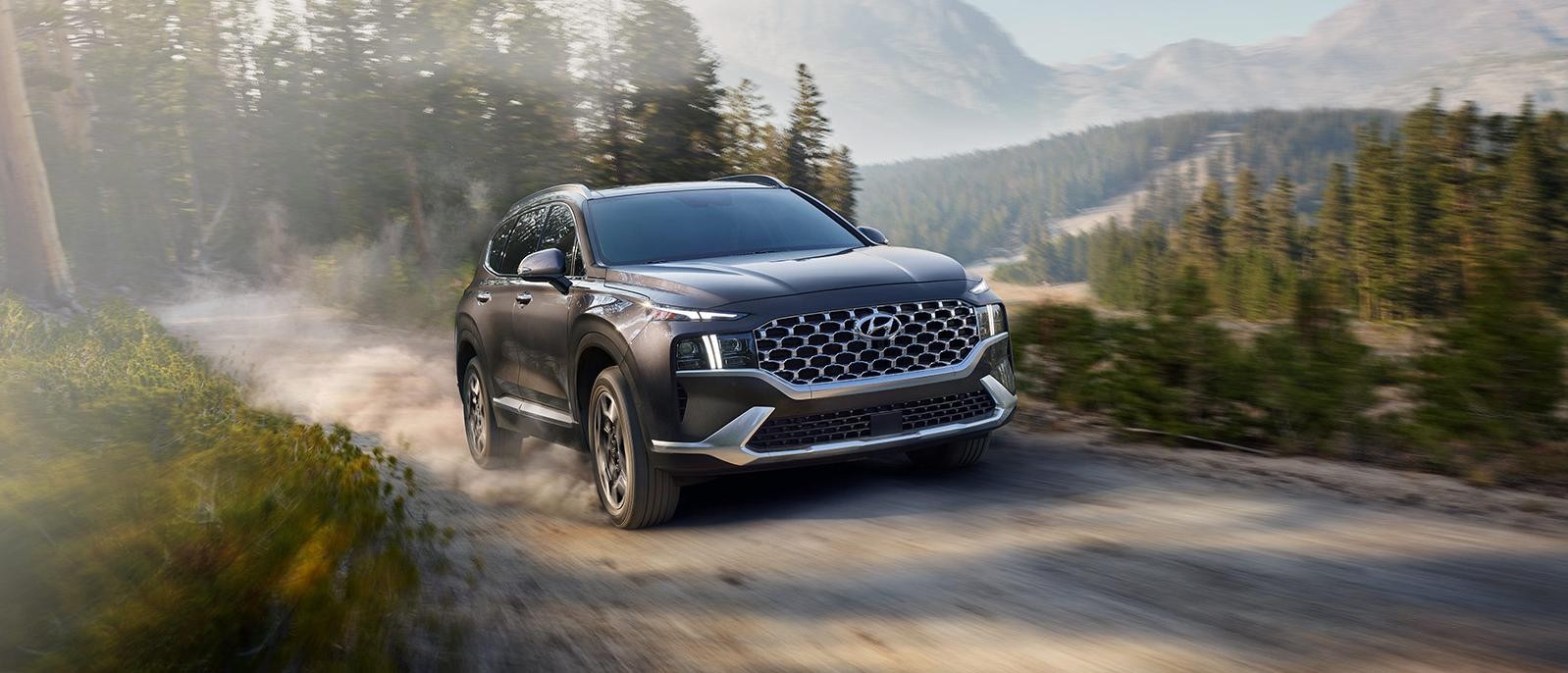 New 2022 Hyundai Santa Fe Hybrid running on mountain road.