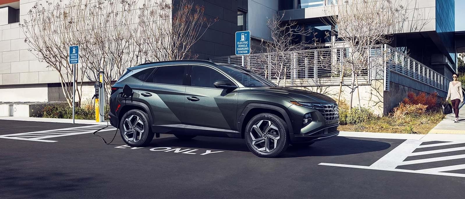 Silver 2024 Hyundai Tucson Plug-in Hybrid running on the road.