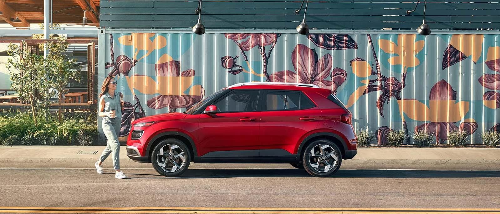 A red Hyundai Venue parked on road.