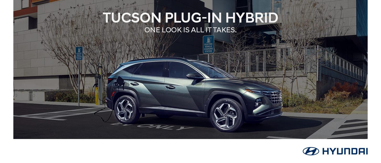 2023 Hyundai TUCSON Plug-in Hybrid parked with buildings in background.