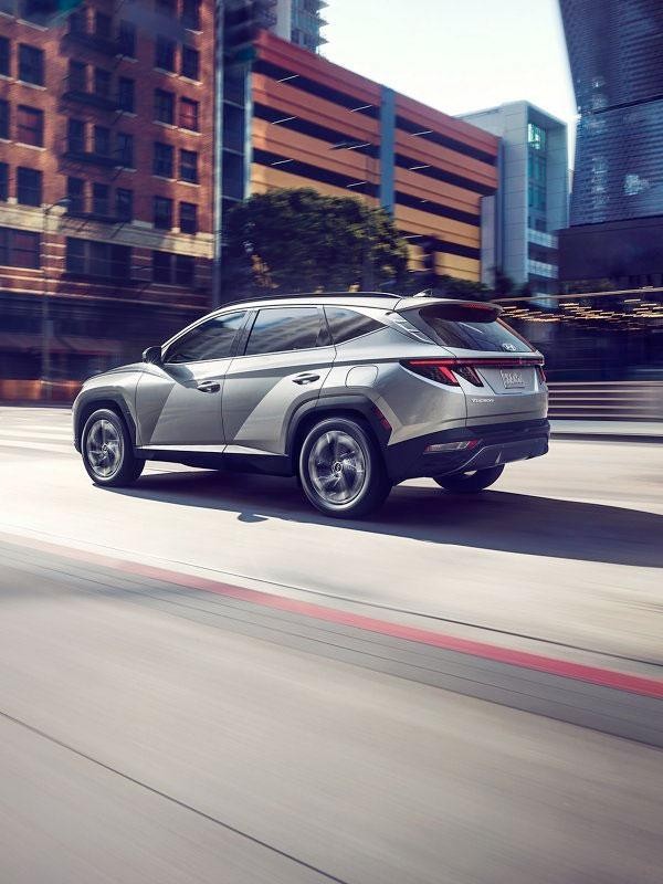 2022 Tucson driving through city - rear angle