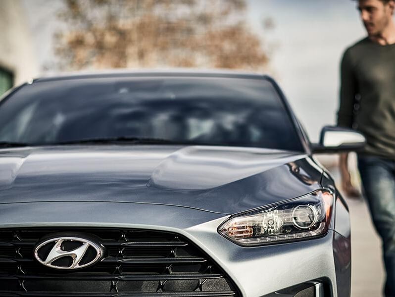 Man walking towards a 2019 Hyundai Veloster