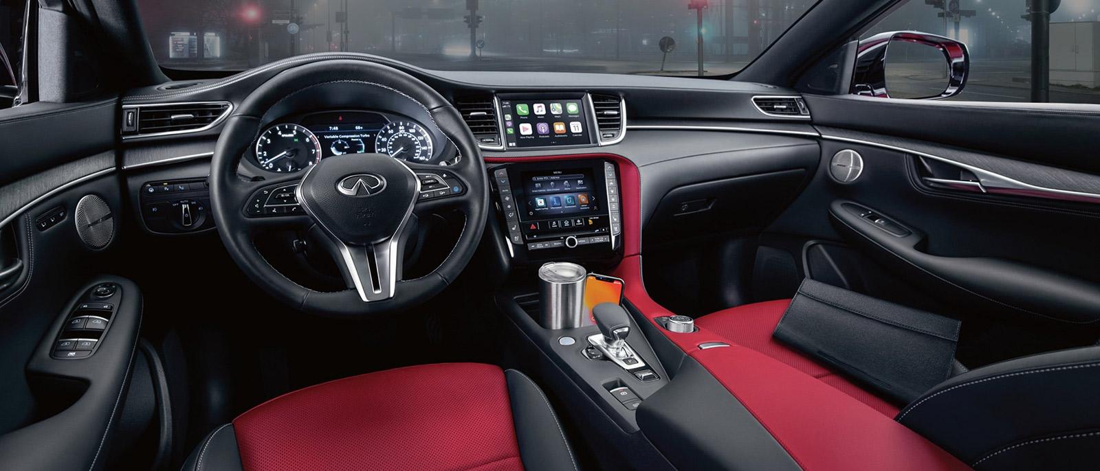 Interior view of the INFINITI QX55 featuring black upholstery with red accents.
