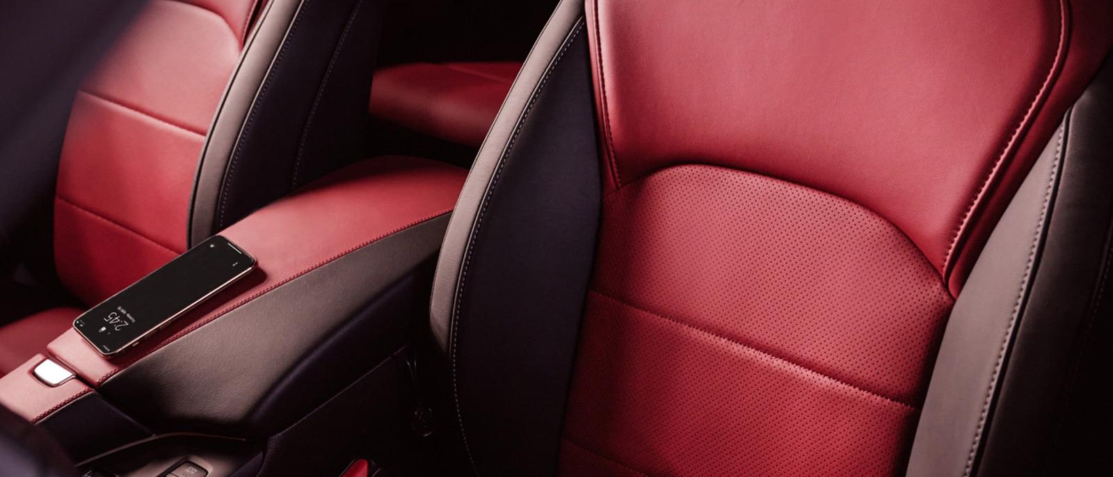 Interior detail of an INFINITI QX55 front seats in red and burgundy leather.