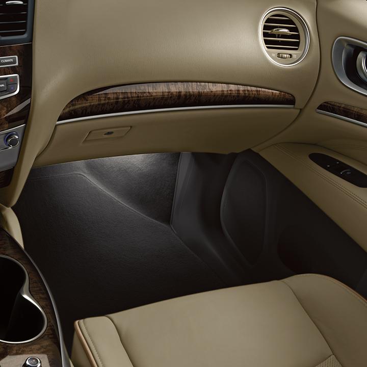 Interior view of an INFINITI QX60 front passenger area featuring wood trim.