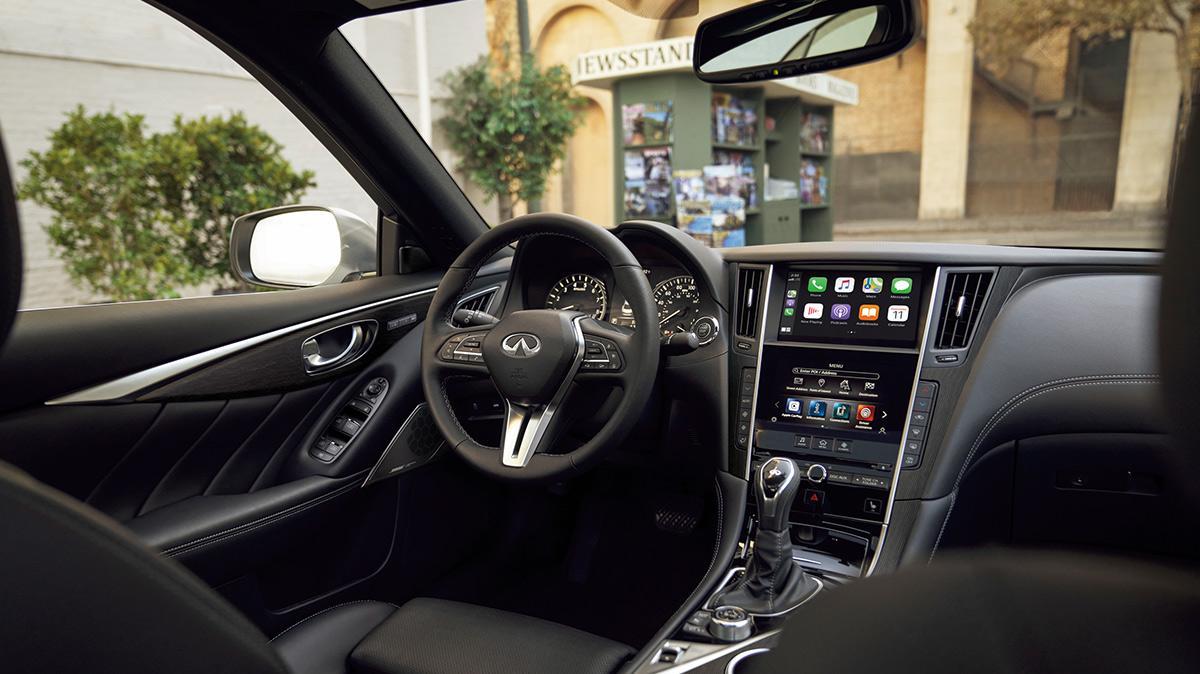 Interior view of an INFINITI Q50 with black upholstery in the city.