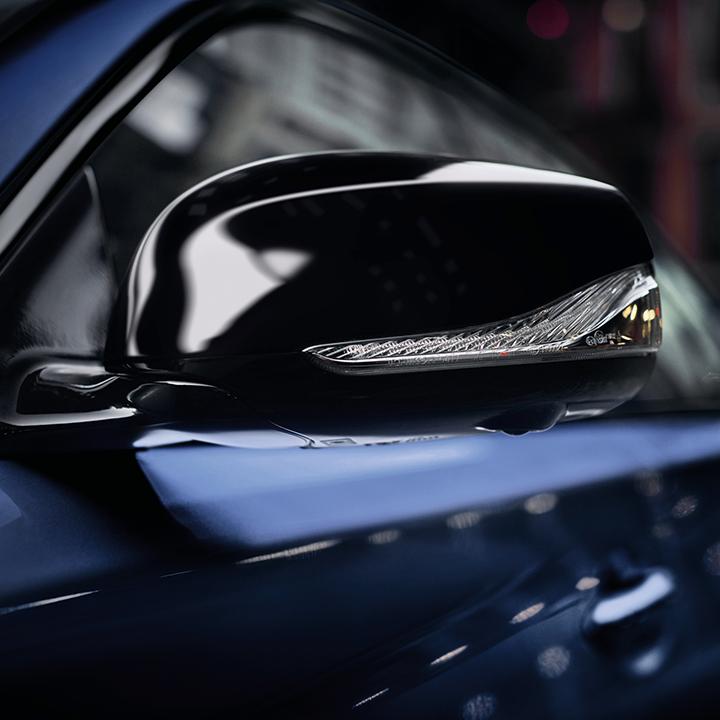 Close-up view of the side mirror on a blue INFINITI Q50.