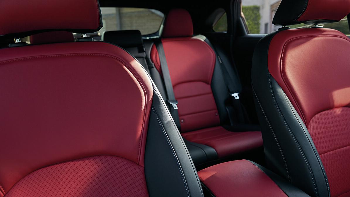 Interior detail of an INFINITI QX55 front seats in red and burgundy leather.