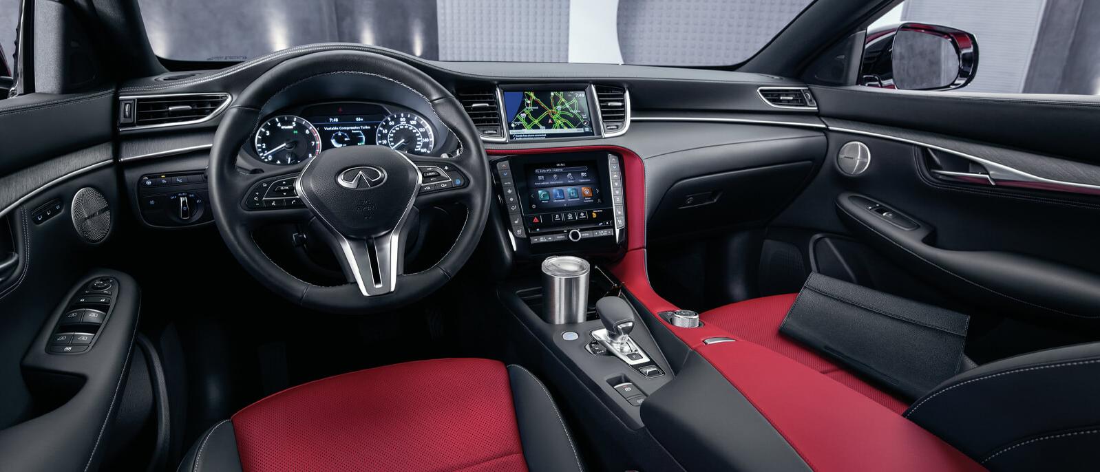 Interior view of the INFINITI QX55 featuring black upholstery with Monaco red accents.
