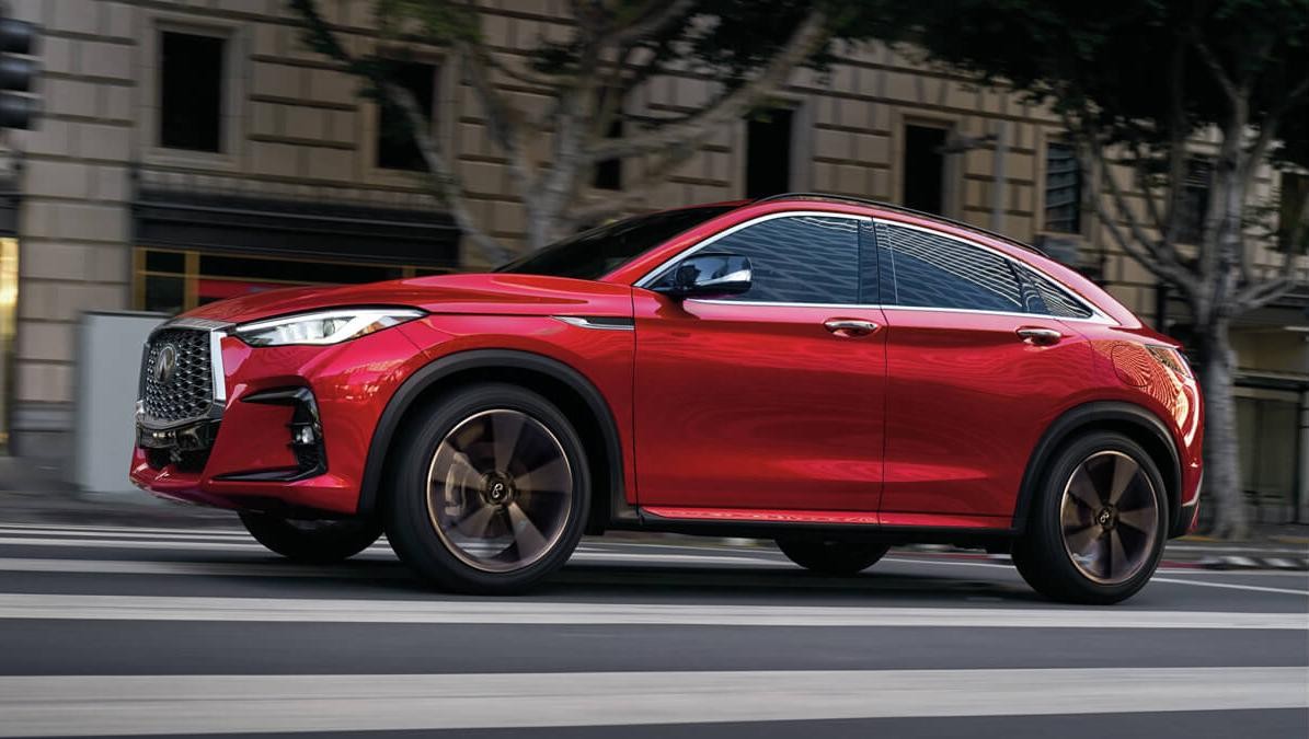 A red QX55 on city street.