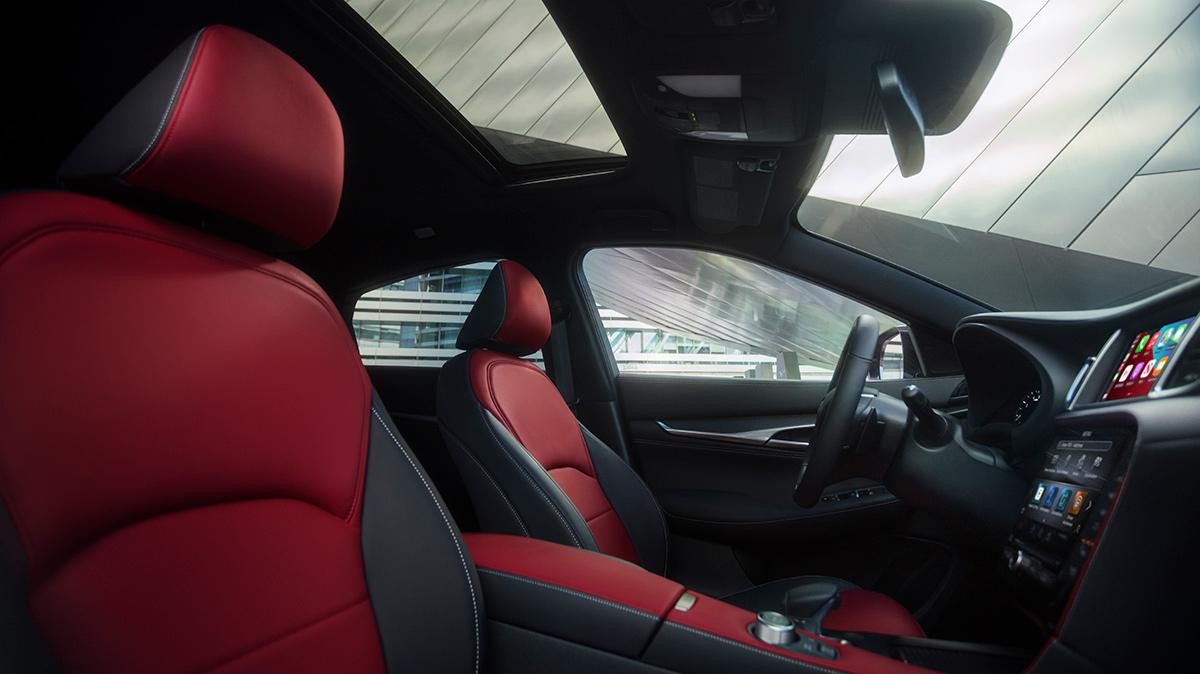 Interior view of an INFINITI QX55 featuring red and dark grey upholstery.