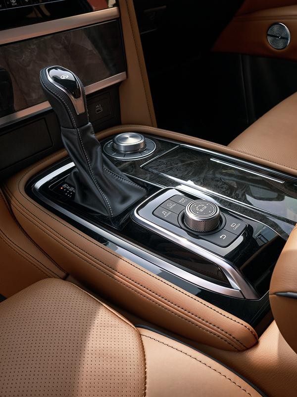 Interior close-up of the INFINITI QX80 shifter console.