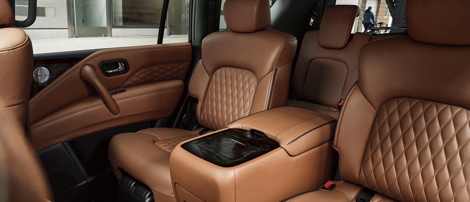 Interior view of an INFINITI QX80 3-row seating in brown leather.