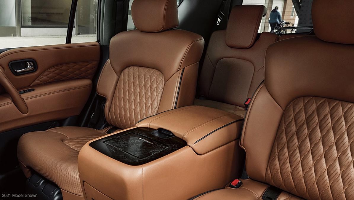 Rear seats of an INFINITI QX80 finished in brown leather.