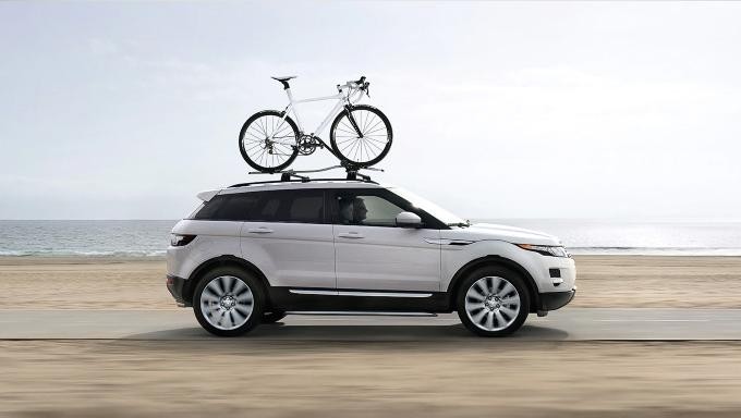 Land Rover Range Rover Evoque driving on road beside water