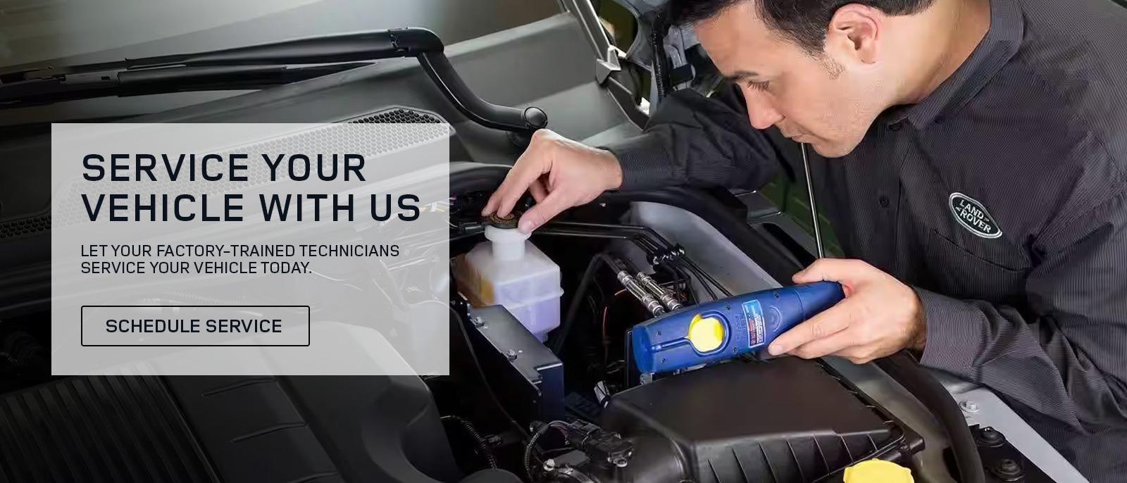 A factory-trained Land Rover technician servicing a vehicle.