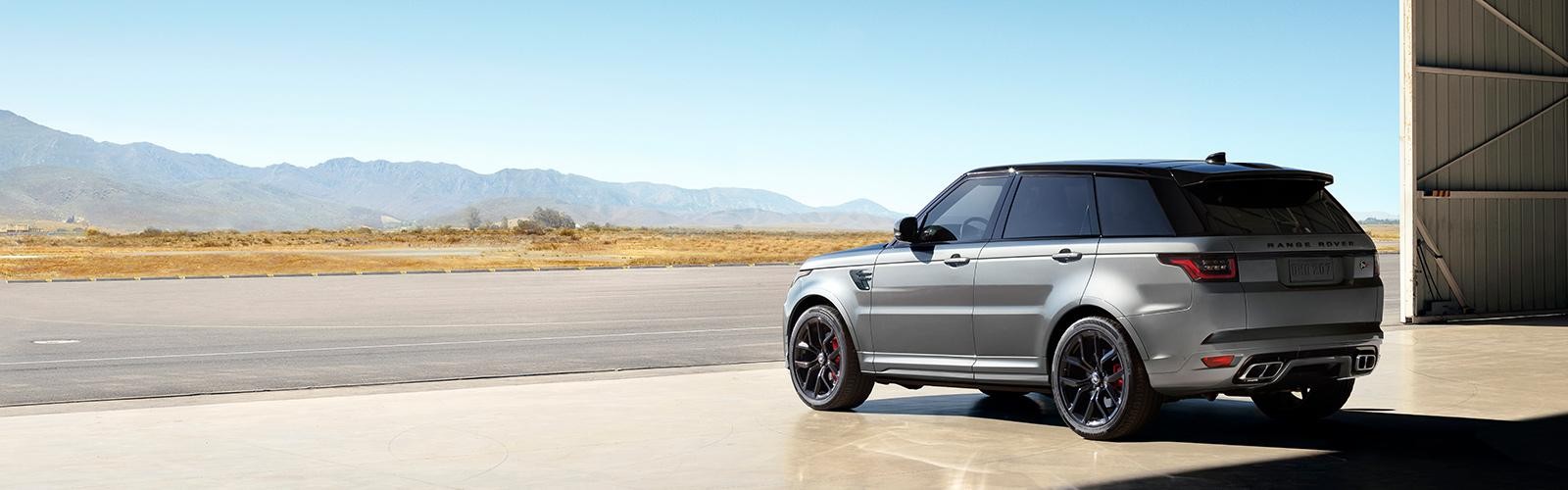 A Silver Range Rover Sport parked in a garage