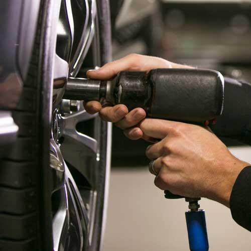 Lexus technician installing a tire on a vehicle