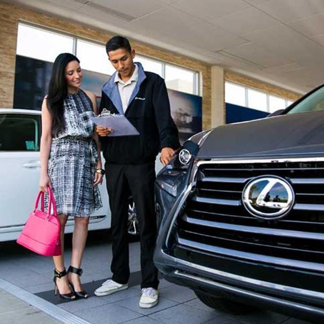 Lexus technician and customer inspecting vehicle