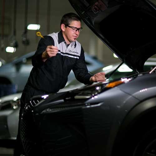 Lexus technician performing an oil change on a vehicle