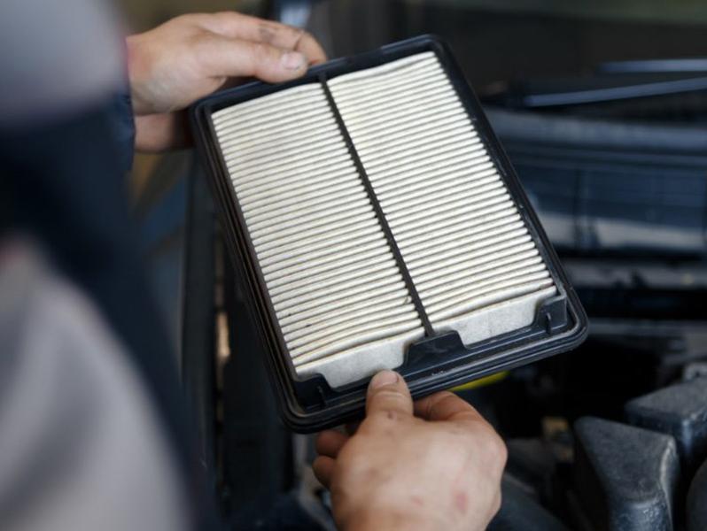 technician looking at air filter