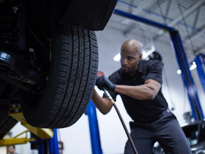 Technician installing tire