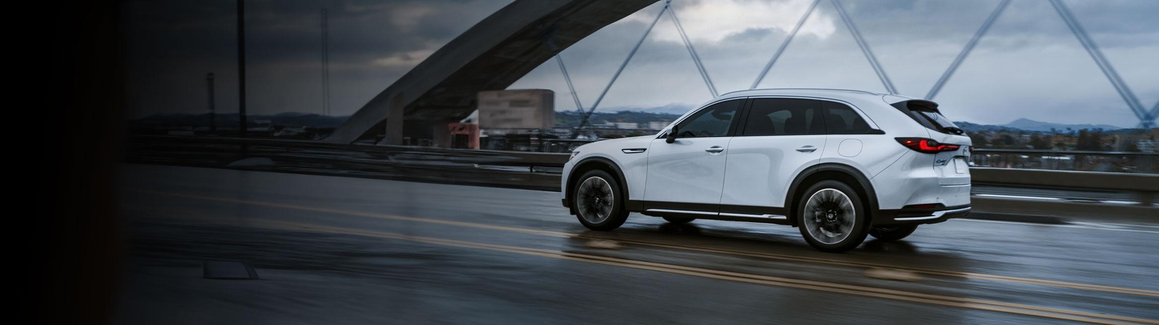 Mazda 2024 CX-90 sprinting on road.