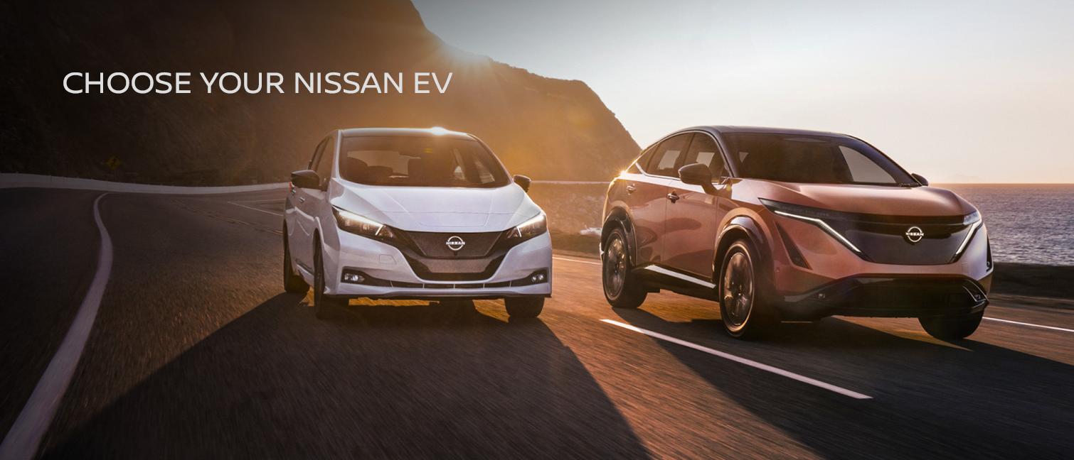 Nissan ARIYA and Nissan LEAF on the open road at sunset
