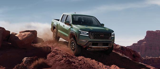 2023 Nissan Frontier is drifting on mountain road.