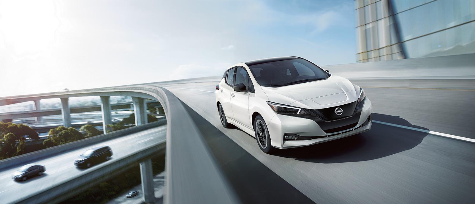 White Nissan Leaf driving on a Flyover