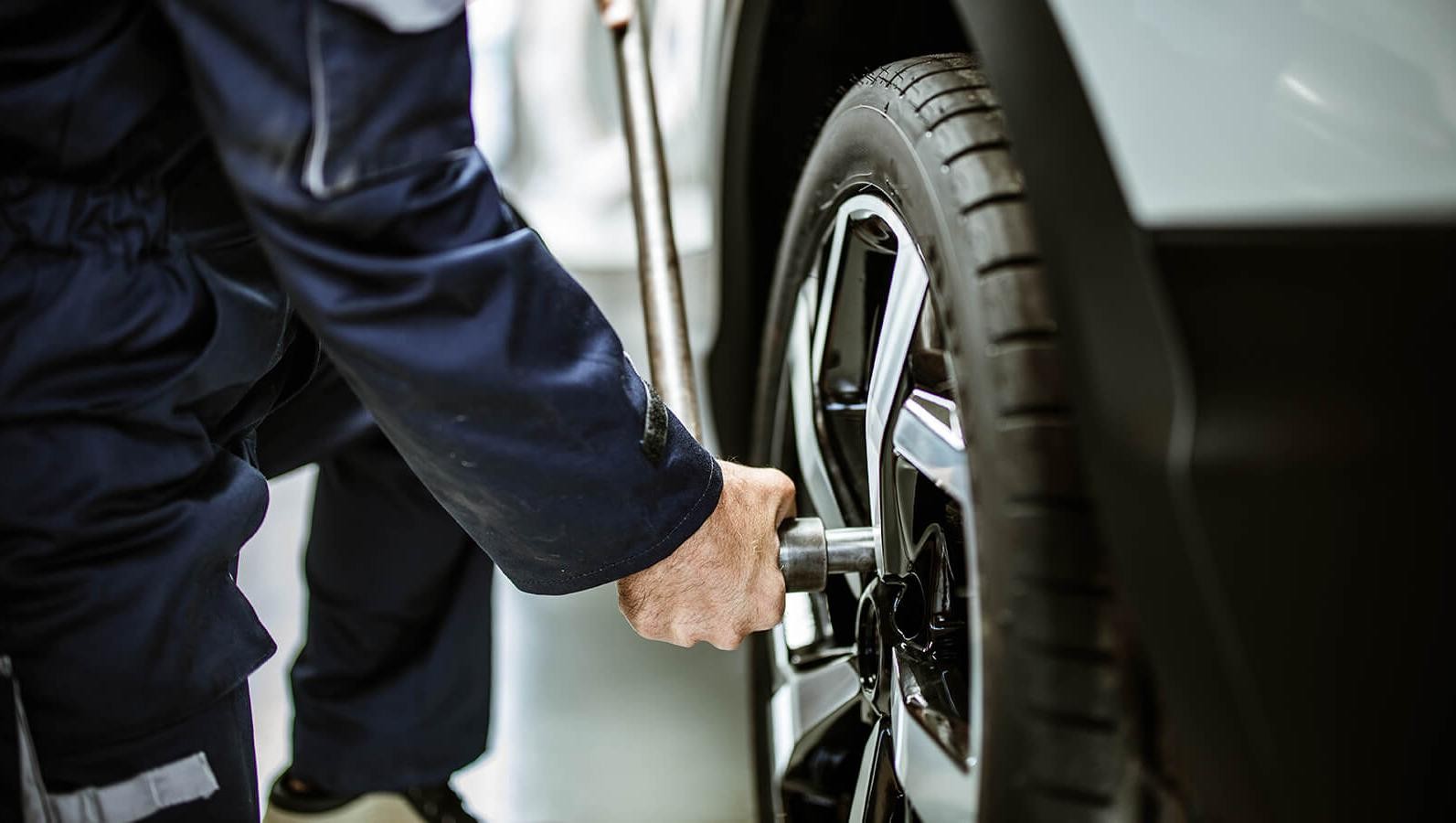 Service technician working on a vehicle tire