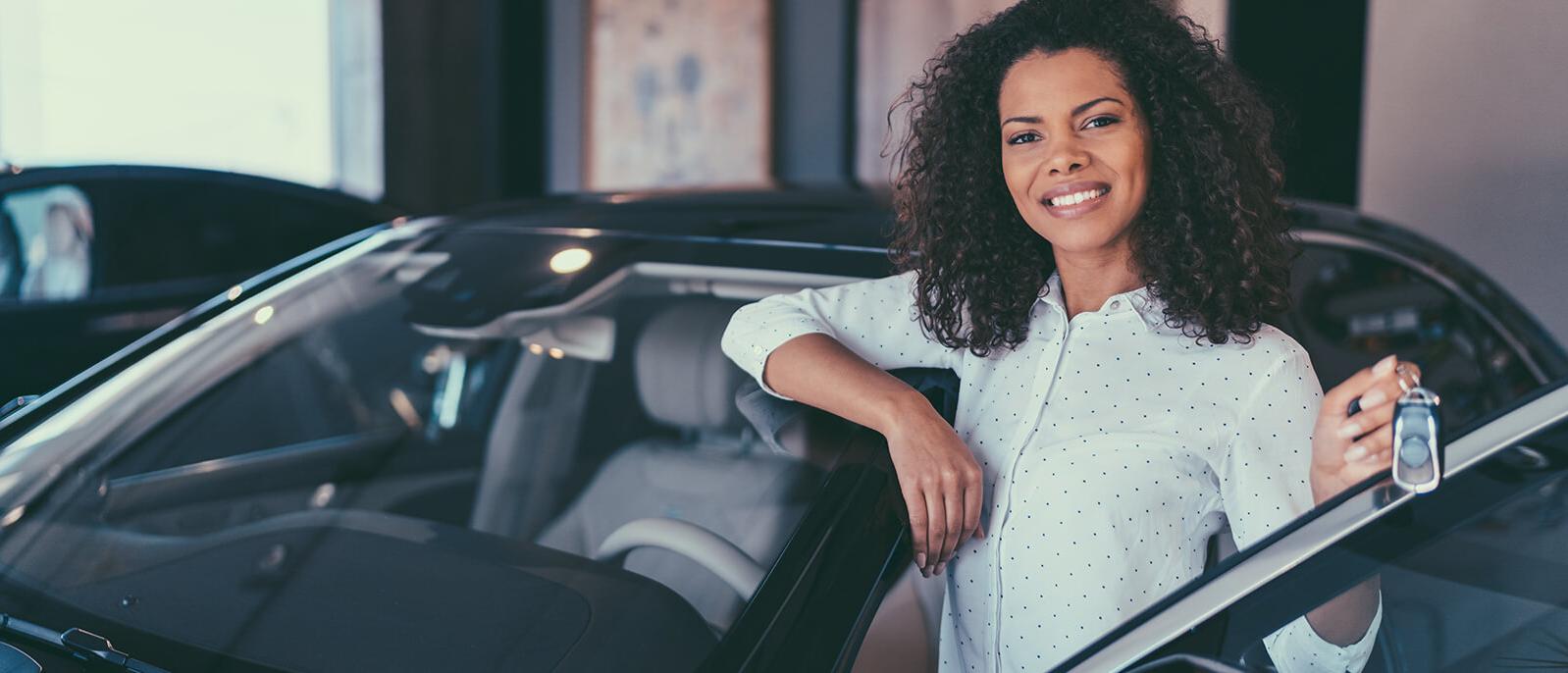 Smiling woman holding new car keys