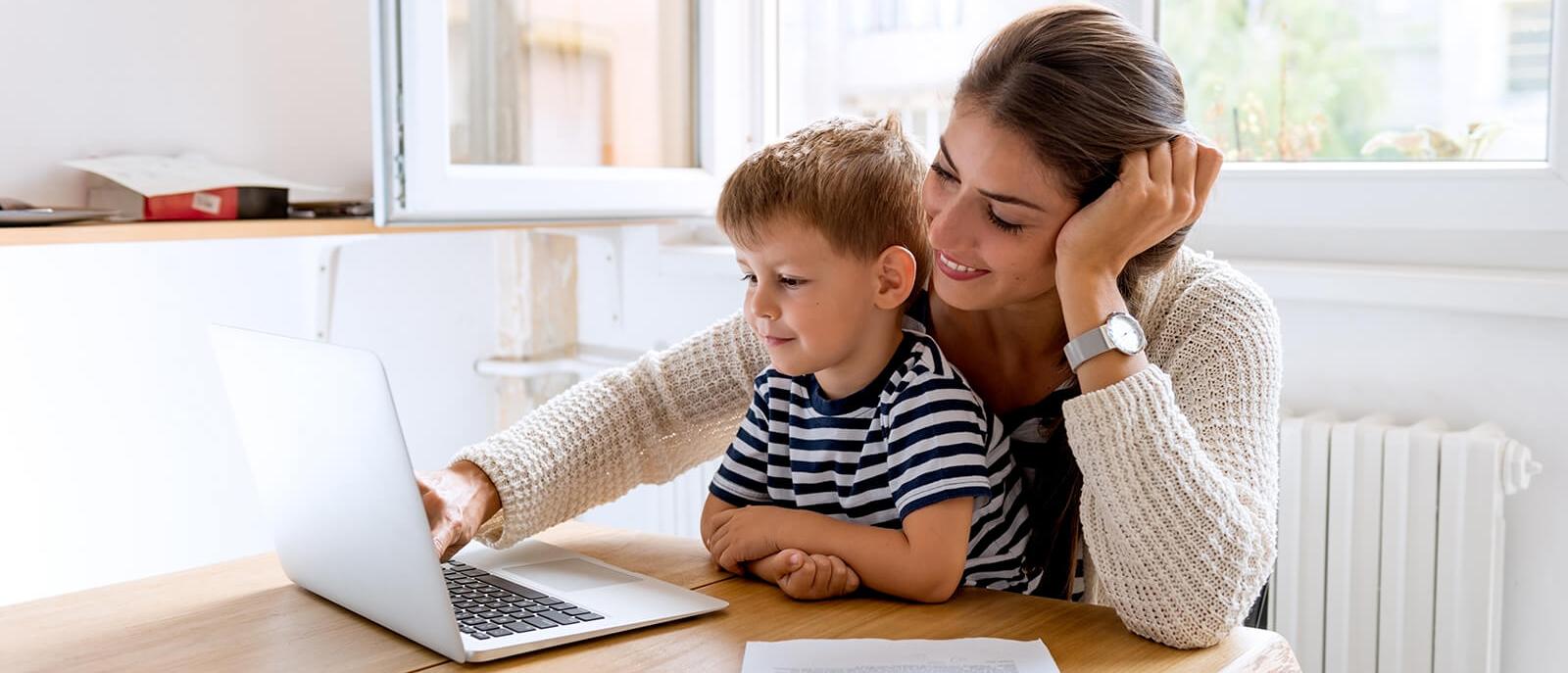 Mother and son at home using a laptop computer