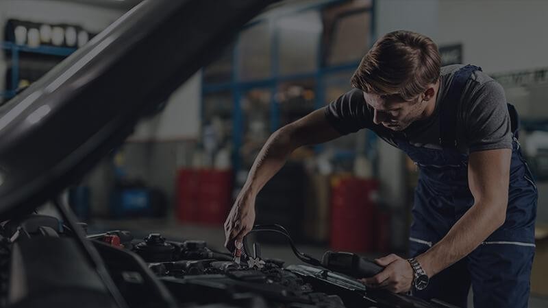 Mechanic working on a vehicle battery