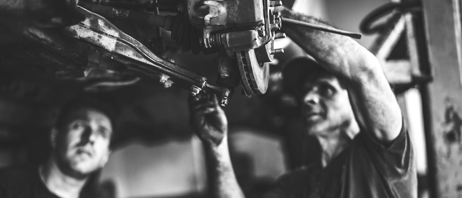 Mechanics working on a vehicle