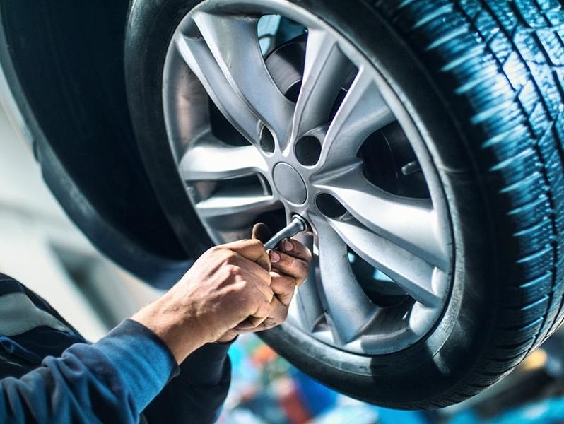 Mechanic working on a vehicle tire