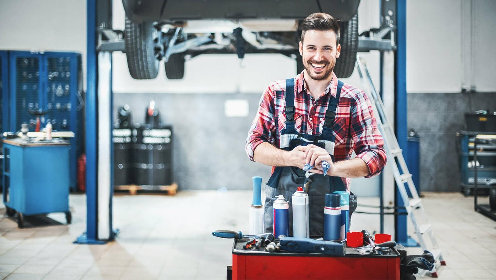 Smiling mechanic in a service garage