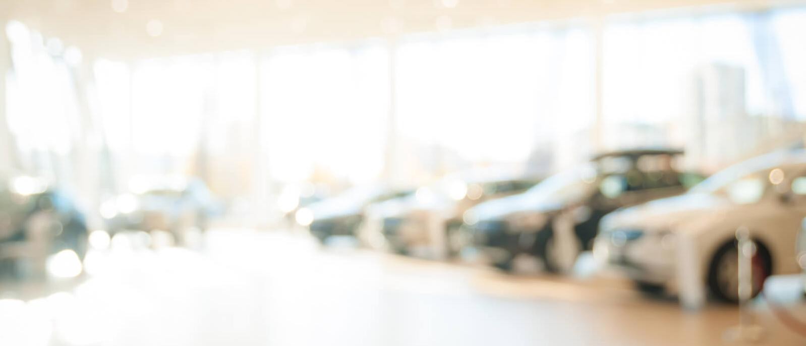 Blurred view of a car dealership showroom