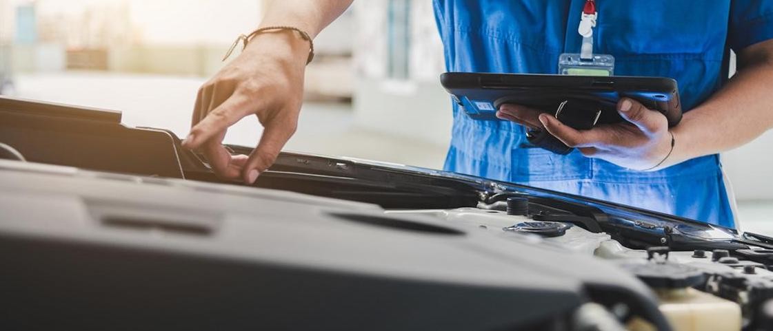 service technician pointing at vehicle