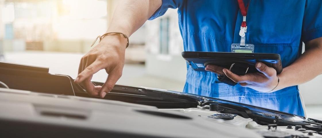 service technician pointing at vehicle