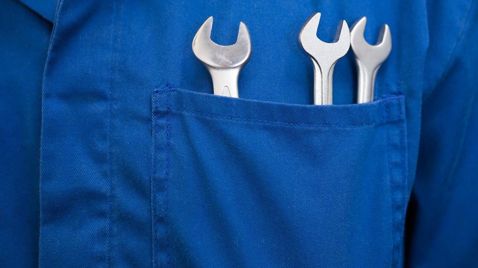 Mechanic's jumpsuit pocket with wrenches in it