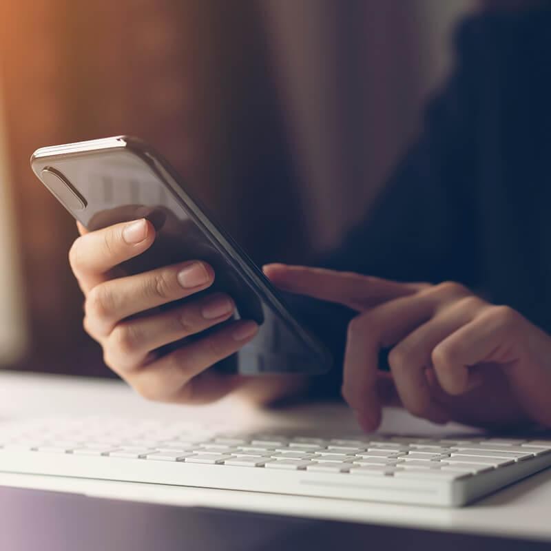 Woman using a phone at her desk