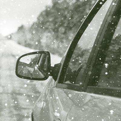 Drivers side mirror on a car in the snow